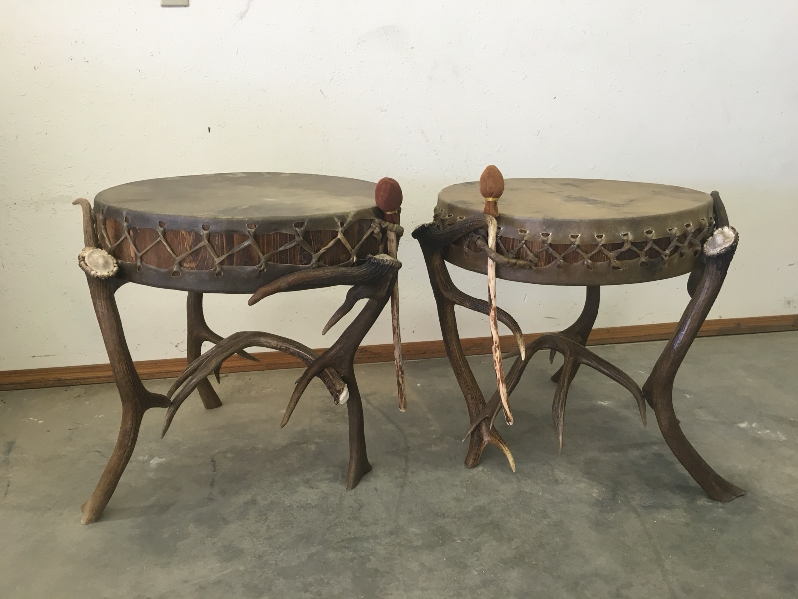 Pair of antler-leg drum end tables with hide tops
