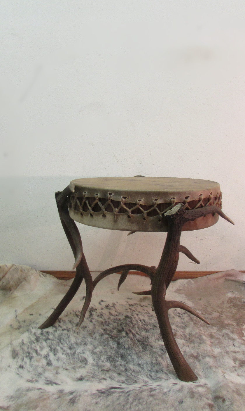 Elk antler end table with a hide-covered top